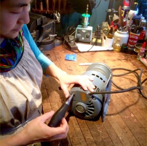 Koko repairing the motor of a small vintage Dayton drill press at the workbench