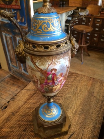 Blue and gilt Sèvres porcelain urn lamp with hand-painted pastoral scene on a wooden bench