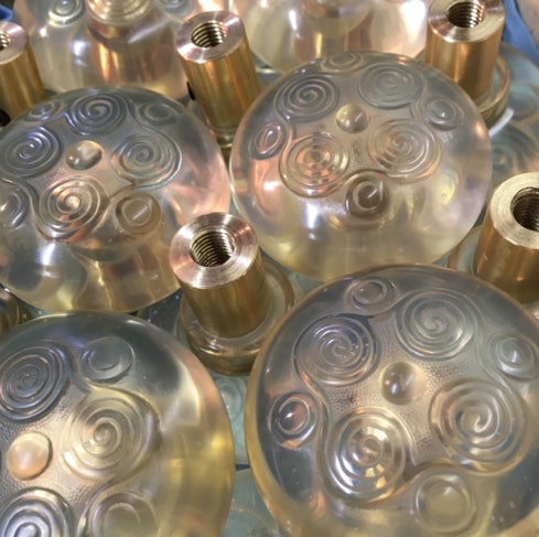 Several clear resin Tiffany-style doorknobs with swirled patterns and brass shanks