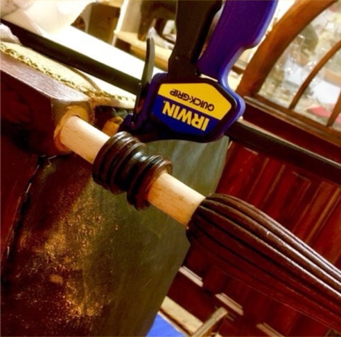 Clamped chair stile repair joining a newly turned section to the original turned wood
