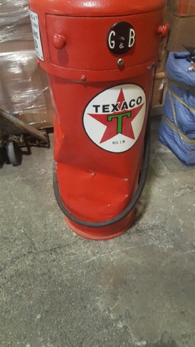 Dented red antique Texaco gas pump with enamel star logo, photographed before restoration