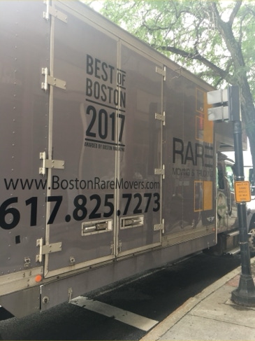 RARE Moving and Trucking box truck parked on a tree-lined city street
