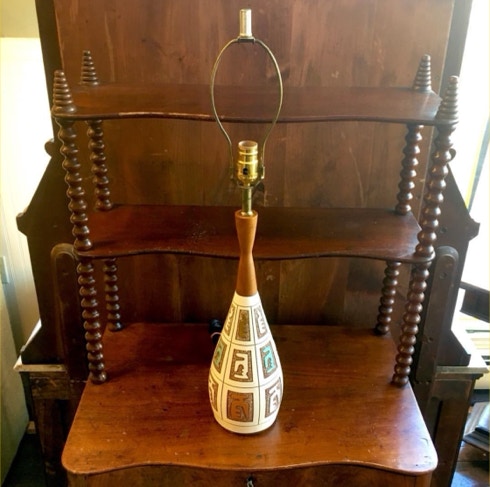 Mid-century ceramic and teak table lamp with a new harp and socket sitting on an antique shelf