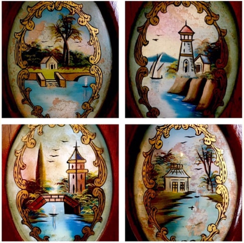 Four hand-painted oval landscape panels behind curved glass on an antique swing bed